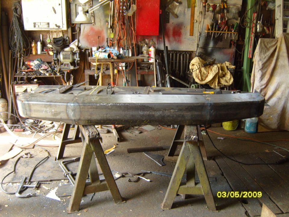 Custom rear bumper on sawhorses in workshop