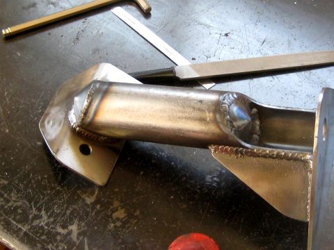 1996 Ford Bronco - A close-up view of a fabricated metal suspension part, showing the details of its construction.