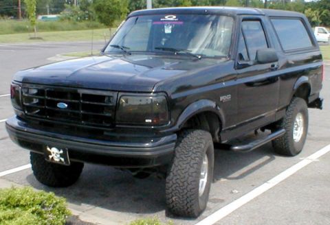 1983 Ford Bronco - This black Ford Bronco features aftermarket wheels and tires, along with a distinctive skull license plate frame.