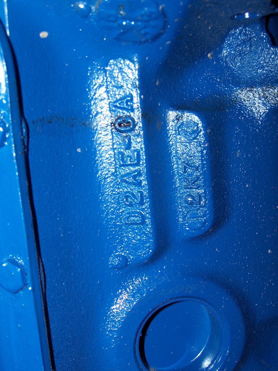 this is the casting and date code of the block; 
"D2AE-CA" means this is a 1971-74 Cobra Jet block (but it only had 2 bolt main caps)
"2K7" means this block was cast in 1972 November 7th.