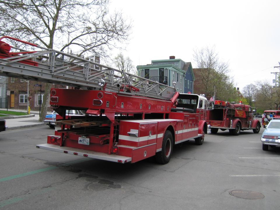 Rear of a red ladder fire truck with extended aerial ladder on a street