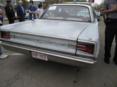 1991 Ford LTD Crown Victoria - Rear view of a primered silver classic sedan with rectangular taillights and a plate reading 28F H2O, surrounded by spectators.