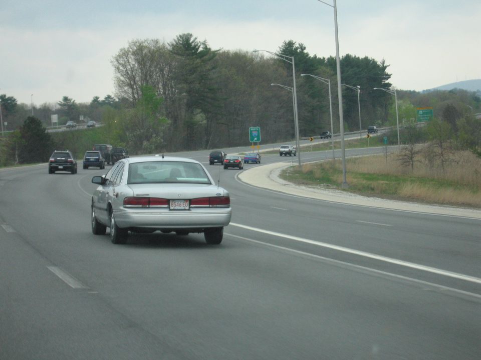 Silver sedan driving away on a divided highway