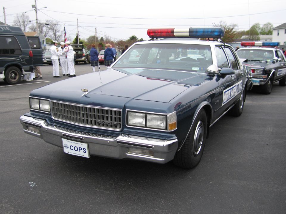 Dark-blue Chevrolet Caprice police sedan with lightbar, front view