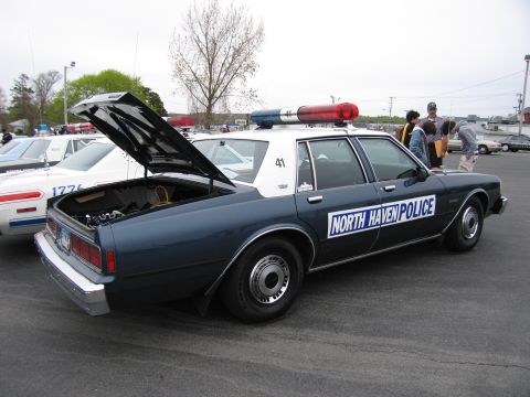 1991 Ford LTD Crown Victoria - dark-blue 'NORTH HAVEN POLICE' sedan numbered 41 with its trunk open and a red roof lightbar, parked at a show.