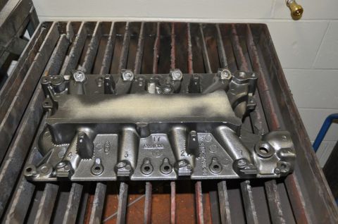 1996 Ford Bronco - Intake manifold with Ford logo and part numbers, likely for a 5.8L engine rebuild.