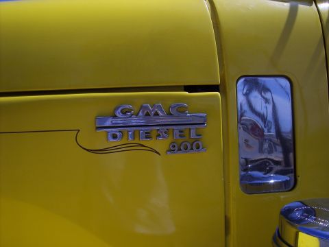 1981 Kenworth W900A - Close-up of a yellow truck's fender with a GMC DIESEL 900 badge.