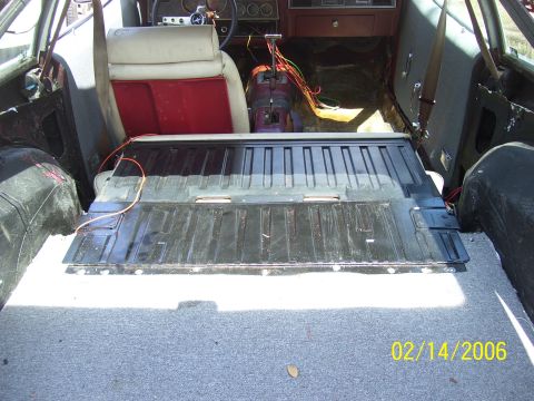 1975 Ford Mustang II - 1975 Ford Mustang II interior, rear seats removed, carpeted cargo area visible.