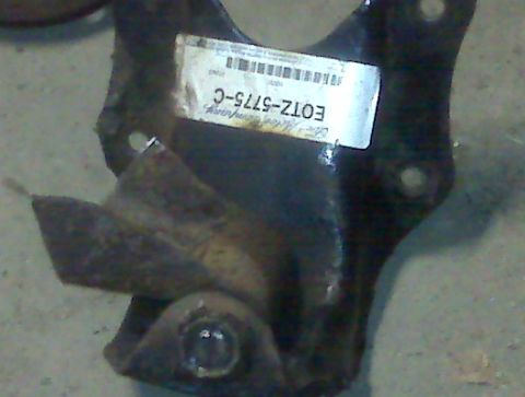 1995 Ford Bronco - A close-up of a metal bracket with a part number label attached.