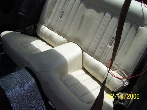 1975 Ford Mustang II - Interior view of a car's rear bench seat, showing upholstery and seatbelts.