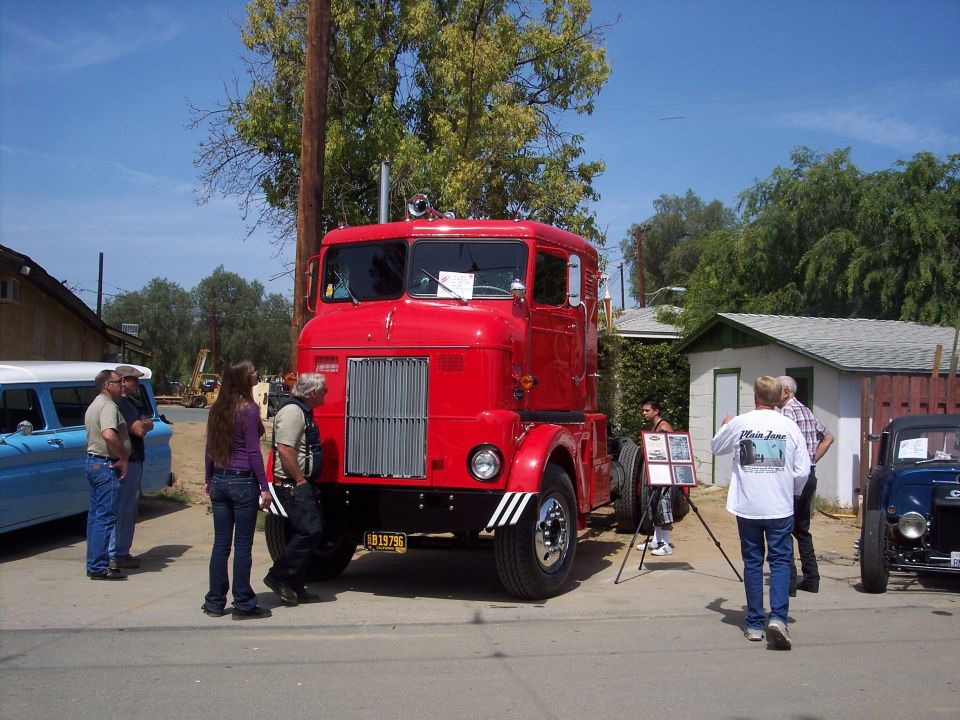 Red cabover truck with chrome grille and white stripe tires. License plate reads B139795