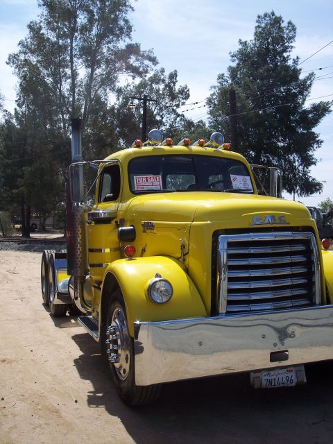 1981 Kenworth W900A - Yellow GMC semi-truck parked outside with a "FOR SALE" sign in the windshield.