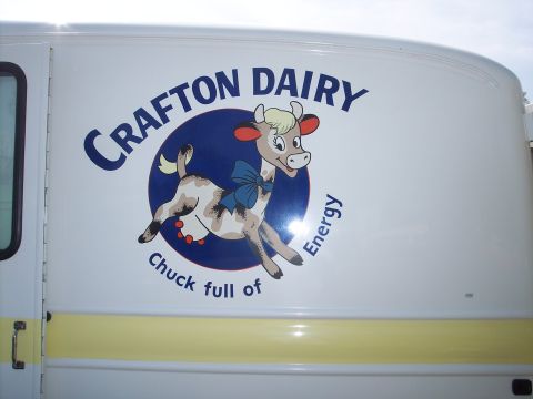 1981 Kenworth W900A - A white truck features the "CRAFTON DAIRY" logo with a cartoon cow and the slogan "Chuck full of Energy".