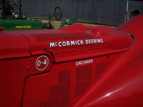 1981 Kenworth W900A - Close-up of a red McCormick-Deering tractor, with another tractor in the background.