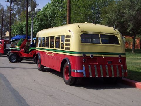 1981 Kenworth W900A - This vintage bus, painted red and yellow with a green stripe, is seen from the rear. Text on its side indicates it was part of the "El Paso…