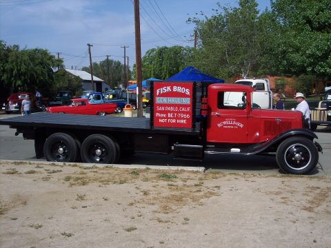 1981 Kenworth W900A - This vintage flatbed truck, possibly a commercial vehicle from an earlier era, is displayed at an event.
