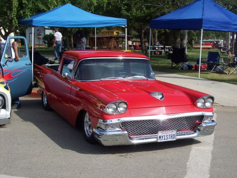 1981 Kenworth W900A - Custom red pickup truck, possibly a Ford Ranchero, at an outdoor event.