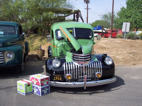 1981 Kenworth W900A - Vintage truck show features a 1946 model with its hood open, alongside another classic truck.