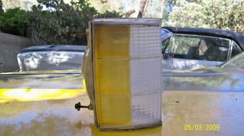 1972 Ford Ranchero - A close-up of a vehicle's tail light assembly, with another car visible in the background.