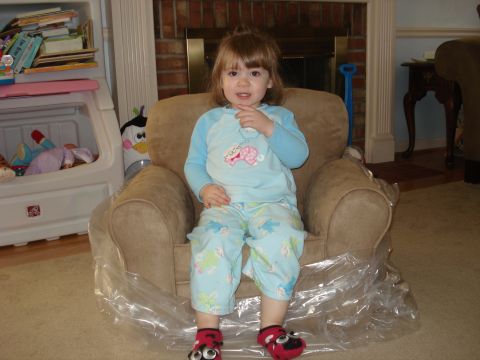 2000 Ford Crown Victoria - A young child sits in a covered armchair, looking towards the camera.