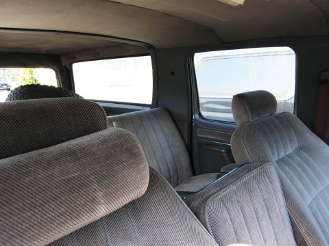 1986 Ford Bronco - Interior of a 1986 Ford Bronco, showing the seats and spare tire.