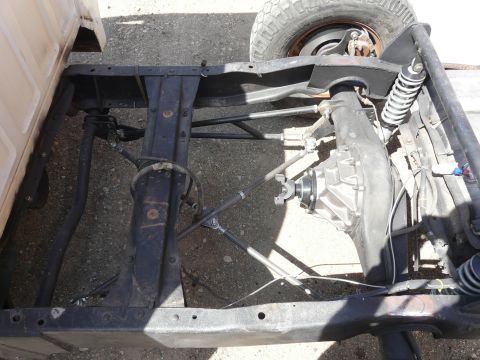 1994 Ford F-150 - Close-up view of the undercarriage of a truck, focusing on the frame and rear axle assembly.