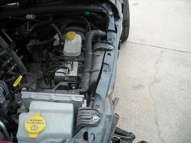 Engine bay with washer fluid reservoir and brake fluid reservoir visible