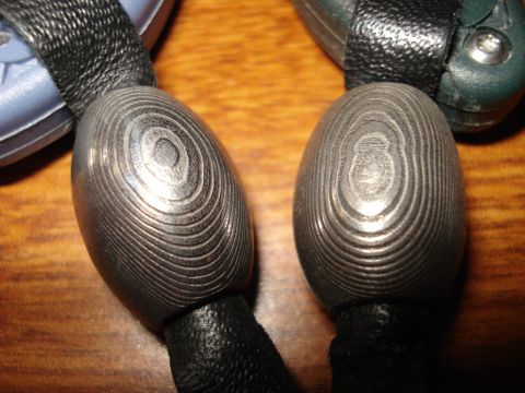 2000 Ford Crown Victoria - Close-up of two key fobs decorative Damascus steel covers with a layered, circular pattern.