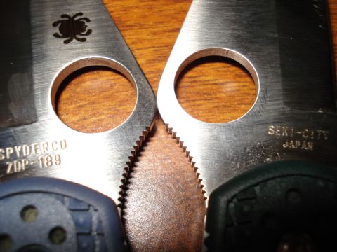 2000 Ford Crown Victoria - Close-up view of two Spyderco knife blades, highlighting their distinct markings and serrated edges.