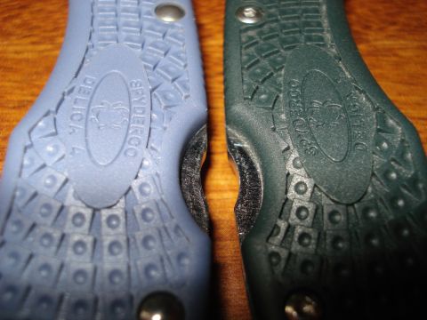 2000 Ford Crown Victoria - Two Spyderco Delica knives, one blue and one green, are shown side-by-side, highlighting their textured handles and embossed branding.