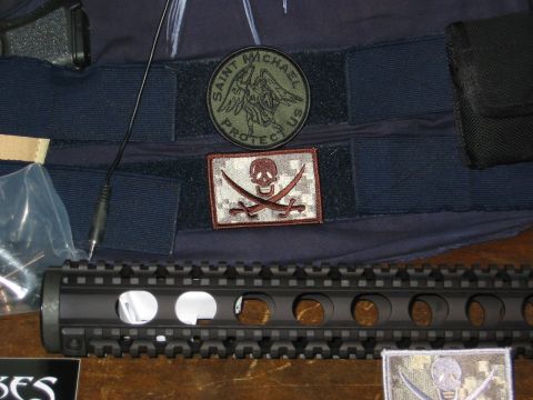 1996 Ford Bronco - Tactical gear, including patches and a rifle component, is laid out on a surface.