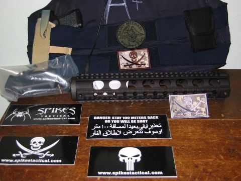 1996 Ford Bronco - A collection of tactical gear, including a rail system, vest, and various patches, is displayed on a wooden surface.