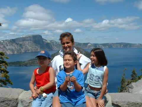 1991 Ford Bronco - A family enjoys a scenic view at Crater Lake National Park on a sunny day.