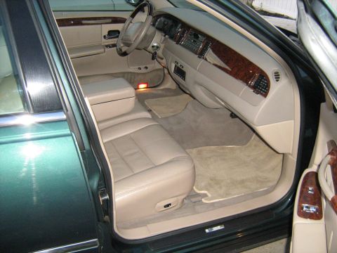 1988 Mercury Grand Marquis - The interior of a green car, showing the front seats, dashboard, and door panel.