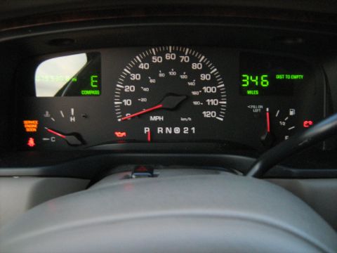 1988 Mercury Grand Marquis - Interior view of a vehicle's dashboard, showing the speedometer, compass, and fuel gauge.