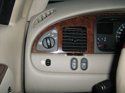 1988 Mercury Grand Marquis - Dashboard interior with wood trim, light controls, and air vents visible.