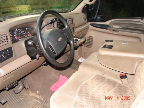 1987 Ford Bronco - Interior view of a truck's dashboard, steering wheel, and seats. Watermark indicates photo taken May 11, 2009.