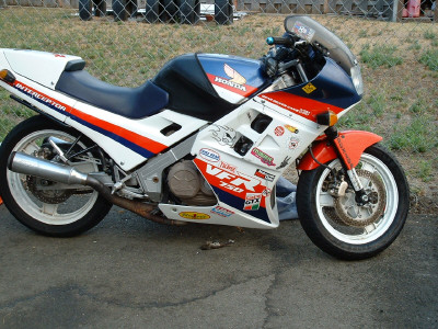 1991 Ford Bronco - A Honda VFR750 Interceptor motorcycle with racing decals is shown from the side.