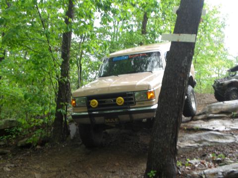 1989 Ford Bronco - This 1989 Ford Bronco is tackling a challenging off-road course through a wooded area.