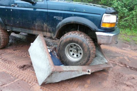 1995 Ford Bronco - Ford Bronco stuck on a couch cushion while off-roading in the mud.