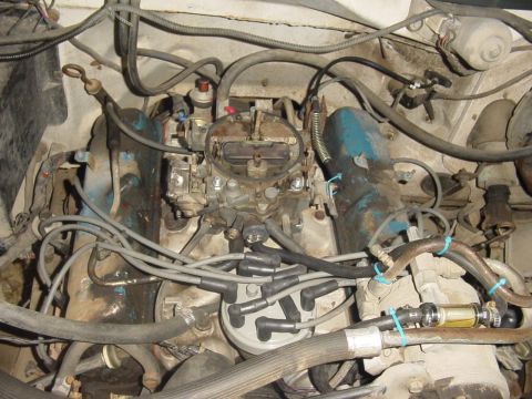 1982 Ford Bronco - Close-up view of an engine bay, showing a carburetor and associated wiring and hoses.