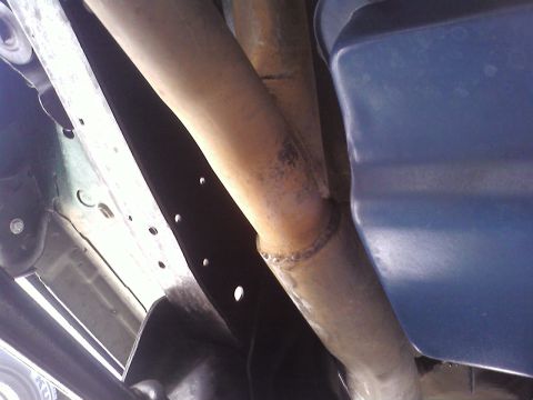 1978 Ford Bronco - Underside view of exhaust pipes and frame structure.
