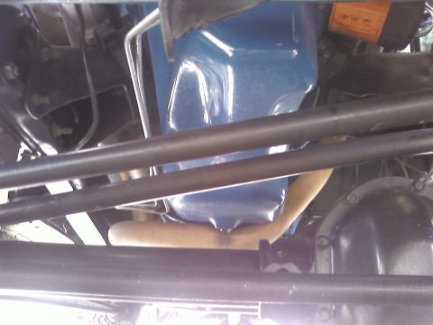 1978 Ford Bronco - A close-up view of the underside of a vehicle, showing mechanical components.