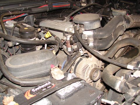 1996 Ford Bronco - Close-up view of an engine bay, showing various mechanical parts and wiring.