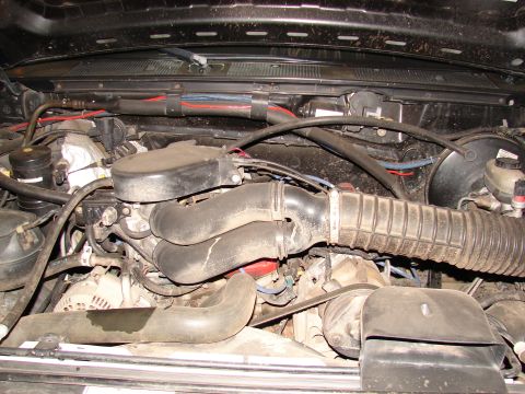 1996 Ford Bronco - Close-up view of an engine bay, showing various mechanical parts and wiring.