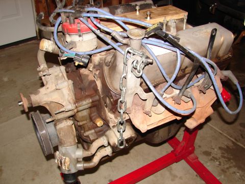 1996 Ford Bronco - Engine assembly on a stand, showing various components and wiring.