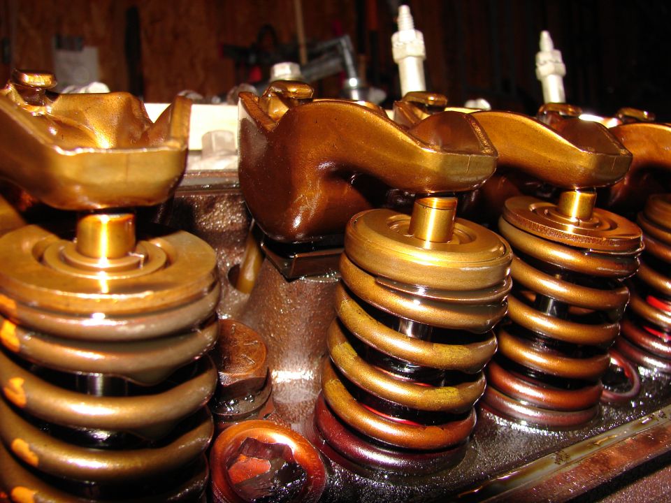 Engine valve springs and rocker arms with golden-brown finish