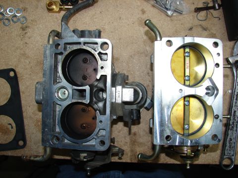 1996 Ford Bronco - Comparison of a clean and dirty carburetor, showing the internal components and throttle plates.