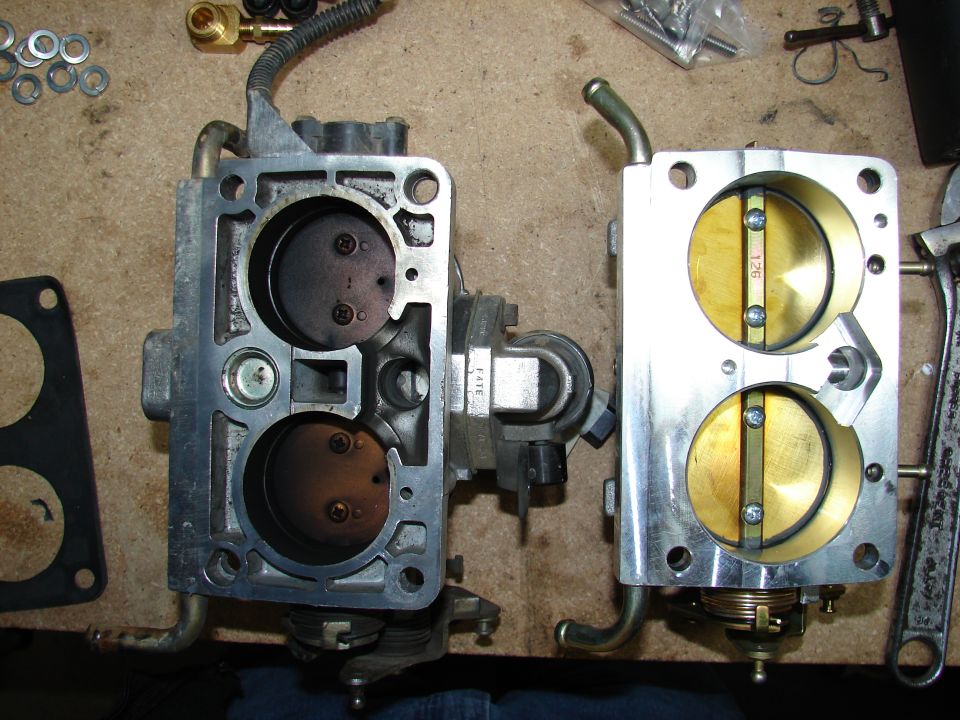 Two carburetors, one clean and one dirty, with visible part numbers