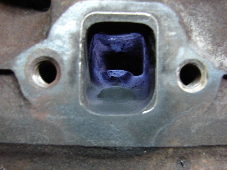 Exhaust port. Notice two bumps, one is for valve, the other had no use for me.  It had to go.  Also, you can see the outline that I will port out.